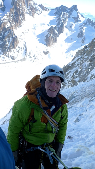 The author using a lightweight belay jacket during a brief stop on the North Face of Les Droites, Chamonix, France.